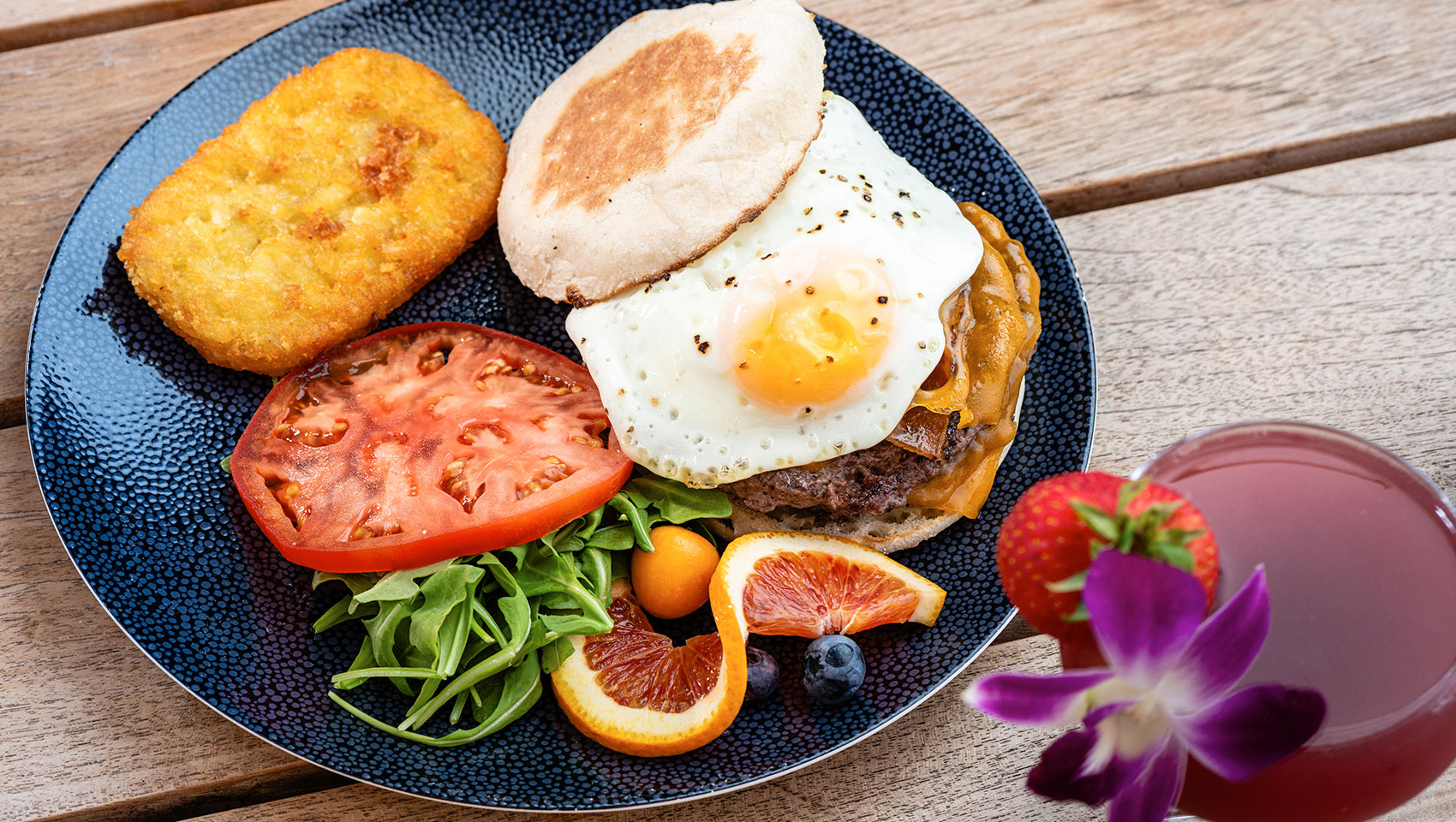 a plate of food with a fried egg and a burger