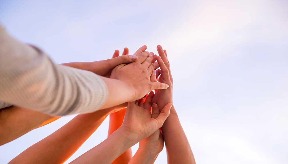 Several hands high-fiving